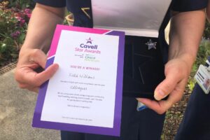 Cavell Award certificate and box held by a female nurse 