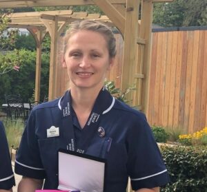 Female nurse in dark blue uniform