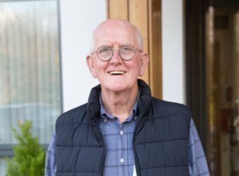 Man with glasses smiling outside Arthur Rank Hospice Charity
