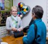 Lady standing at till paying