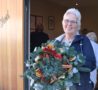 Lady with flower arrangement after completing activity in Arthur's Shed