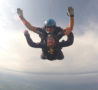 Two people in the air during parachute jump