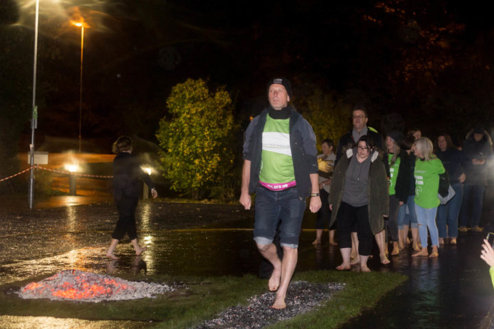 Male walking over coals