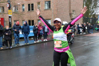 Female hands in the air smiling wearing running gear
