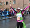 Female hands in the air smiling wearing running gear
