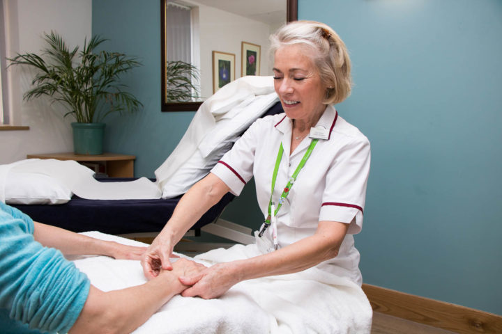 Complementary Therapist giving a hand massage