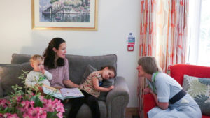 Woman with two young children talks to Nurse