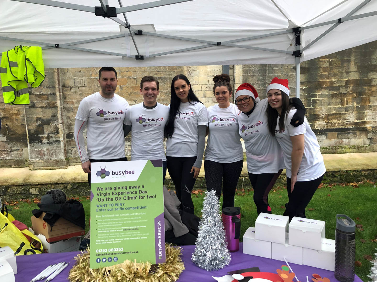 Corporate Sponsorship Busy Bee Case Study a group of people smiling at the camera at a stall