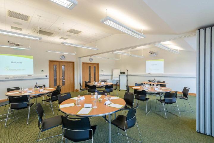 Round tables set up in Education & Conference Centre, ready for delegates