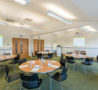 Round tables set up in Education & Conference Centre, ready for delegates