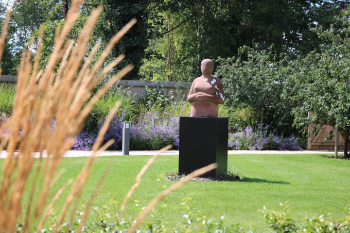 Statue with daisy chain around her neck