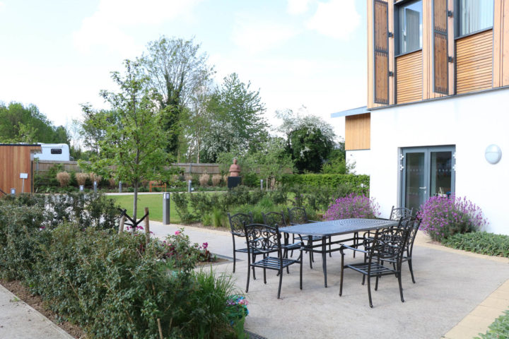 Table and chairs outside Day Therapy lounge, with grass behind