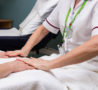 Patient's hands on towel as Therapist delivering hand massage