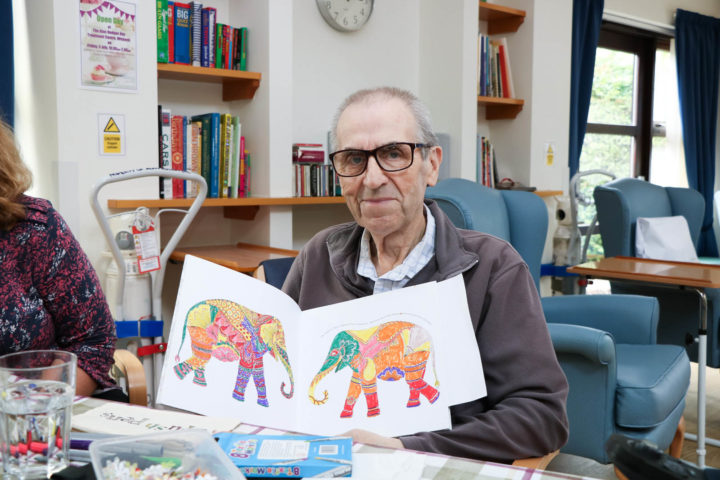 Man with his brightly coloured artwork