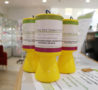 Three bright yellow collection tins with Arthur Rank Hospice Charity labels