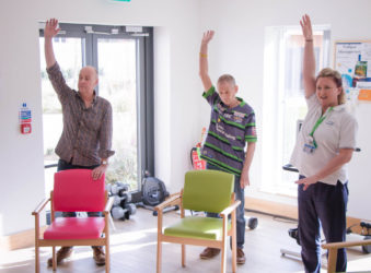 Patients taking part in arm exercises with Occupational Therapist