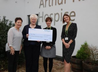 four females holding a big cheque donation
