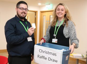 Male colleague selects a winning ticket from our raffle box