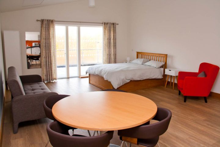 Bed, table and lounge in family apartment