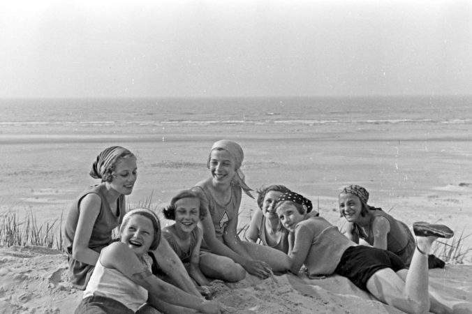 A black and white photo of young females at the seaside