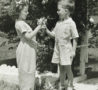 a young boy giving a young girl flowers