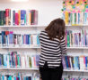 Colleague peruses book shelves of Hospice's Library