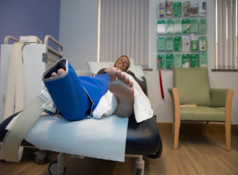 Lady on a bed with bandaged leg