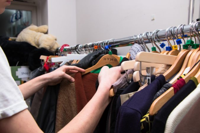 hands with clothes and hangers