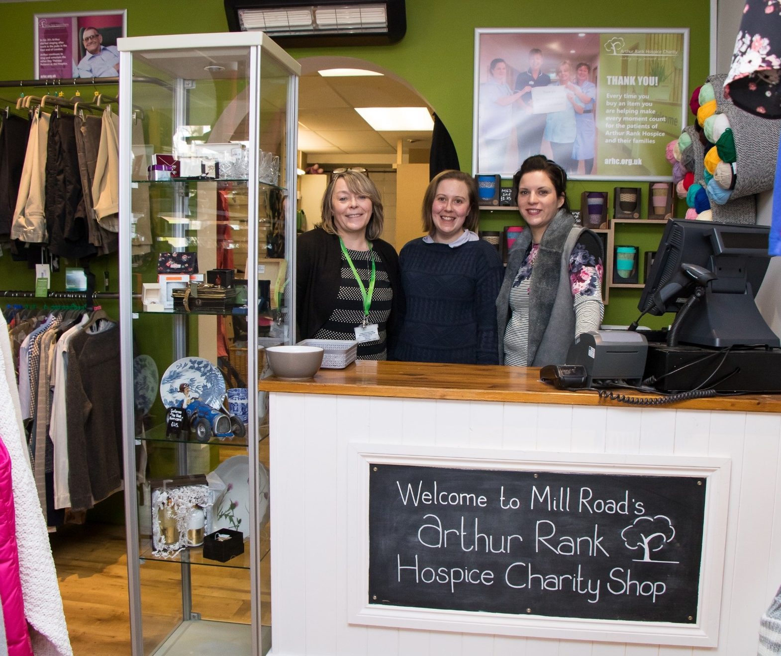 Shops team behind the counter at our Mill Road charity shop