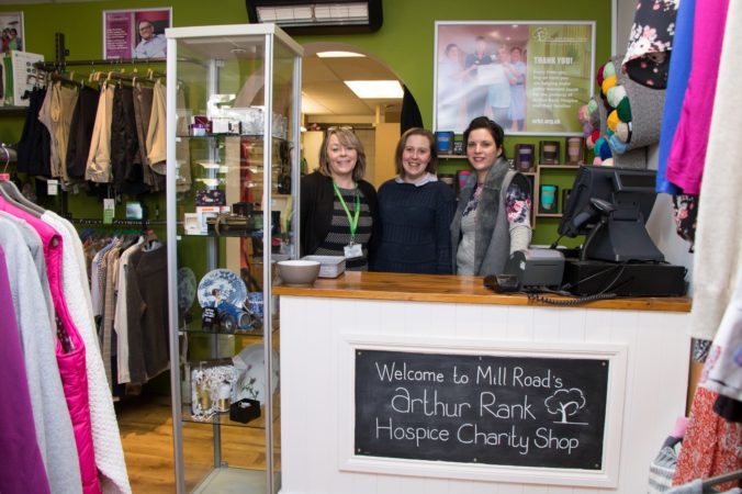 Shops team behind the counter at our Mill Road charity shop