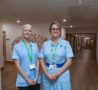 Nurses in uniform with corridor of Hospice behind