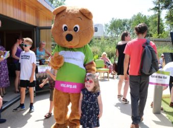 Life sized bear outside with child