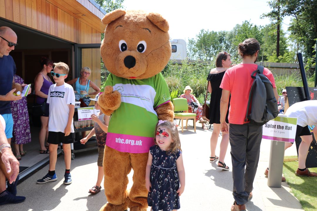 Life sized bear outside with child