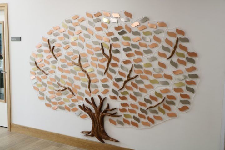 The Memory Tree with gold, silver and bronze coloured leaves engraved with a loved one's name
