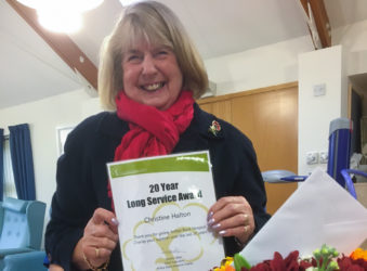 Volunteer Chris Halton smiles after being presented with thank you gifts and a special certificate recognising 20 years of service to the Wisbech-based Alan Hudson Day Treatment Centre (part of Arthur Rank Hospice Charity)