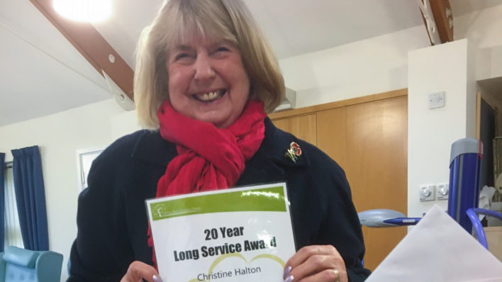 Volunteer Chris Halton smiles after being presented with thank you gifts and a special certificate recognising 20 years of service to the Wisbech-based Alan Hudson Day Treatment Centre (part of Arthur Rank Hospice Charity)