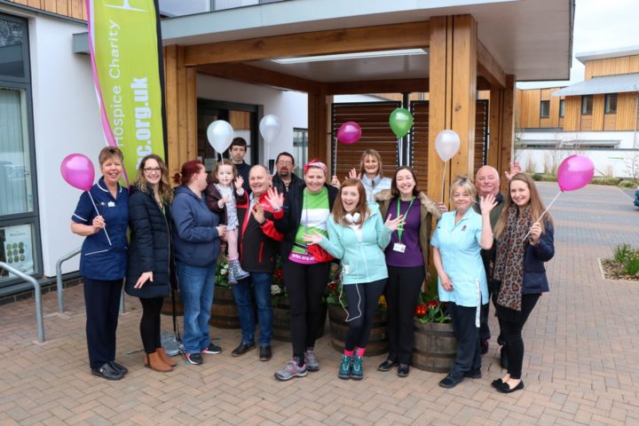 Group of supporters with balloons at front of Hospice