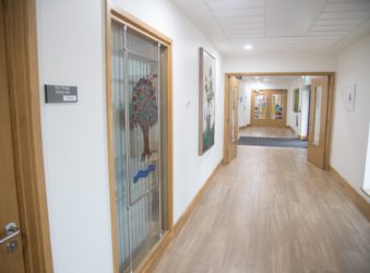 Arthur Rank Hospice Charity proudly displays the Royal stained glass window, previously housed at the Mill Road site, in the Evelyn Day Therapy Window at Shelford Bottom, Cambridge