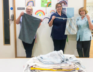 Some of the nursing team in the Inpatient Unit with donations of home-made scrubs