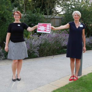 Gemma Manning, HR Director and Sharon Allen, CEO holds up our pledge for Time to change in Arthur Rank Hospice gardens in September 2020.