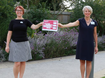 Gemma Manning, HR Director and Sharon Allen, CEO holds up our pledge for Time to change in Arthur Rank Hospice gardens in September 2020.