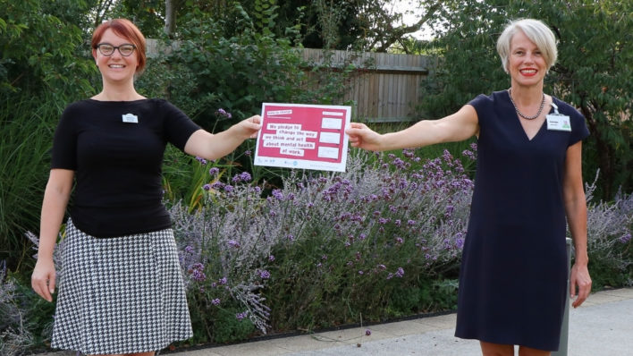 Gemma Manning, HR Director and Sharon Allen, CEO holds up our pledge for Time to change in Arthur Rank Hospice gardens in September 2020.
