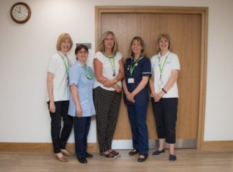 Five members of the Lymphoedema team standing together in the Bradbury Wellness Centre, before the pandemic began