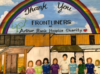 Painting with a rainbow above the Hospice and members of the team in uniform and the words 'Thank you Frontliners of Arthur Rank Hospice Charity' with a heart