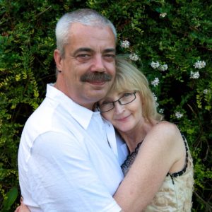 Linda with her arms wrapped around Martin, on their wedding day in 2010