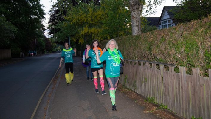 Star Shine Night Walk participants in the path waving