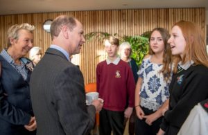 : (Right to left) Alice Webb, Jodie Lawler and Morgan Larter tell The Earl more about the volunteering work they are undertaking in the Hospice’s charity shops as part of their Duke of Edinburgh Award