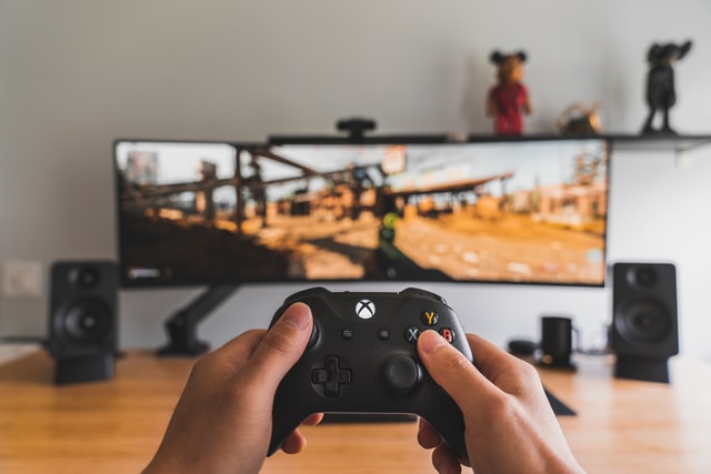 Gamer with controller - photo by SamPak