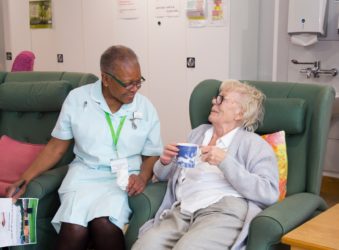 Female patient with a cup of tea, chats to healthcare assistant in the Evelyn Living Well Centre