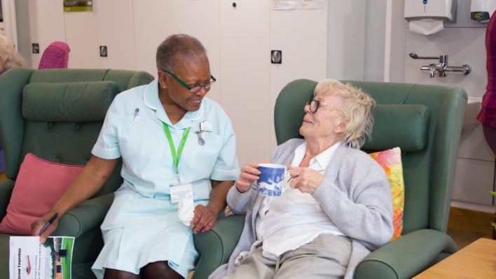 Female patient with a cup of tea, chats to healthcare assistant in the Evelyn Living Well Centre